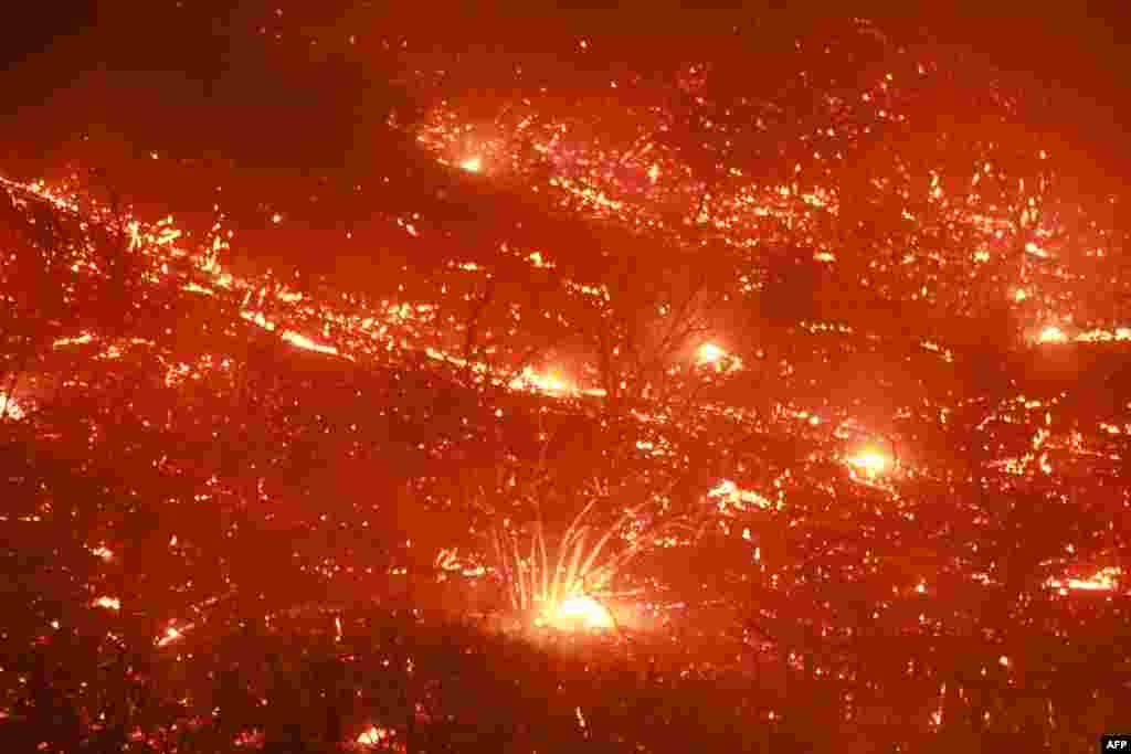 Embers fly through the air as Highway 330 is engulfed in flames from the Line Fire near Running Springs, California, Sept. 7, 2024. California Governor Gavin Newsom and San Bernardino County authorities declared a state of emergency. The Line Fire has burned more than 7,000 acres (2,800 hectares).