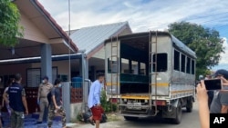 In this photo released by the San Sai District Administrative Office, three journalists working for Democratic Voice of Burma, prepare to get into a van after being arrested at San Sai District in Chiang Mai province north of Thailand May 9, 2021.