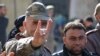 A man wearing a Turkish officer's uniform flashes the Grey Wolves (a Turkish far-right ultranationalist organization) sign, during a demonstration in support of neighbouring Turkey in the Syrian town of Bizaa, north of Aleppo on Dec. 21, 2018.