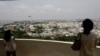 FILE - Visitors look out over U.S. Marine Corps Air Station Futenma in Ginowan on Okinawa, Japan, May 3, 2010. The Japanese and U.S. governments want the Futenma Air Base located in the middle of a crowded city moved to a sparsely populated area for safety reasons.