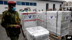 In this Aug. 6. 2021, photo, a Kenyan soldier guards a consignment of 182,000 COVID-19 vaccines from the Greek government via the COVAX facility, at Kenya Jomo Kenyatta airport in Nairobi.